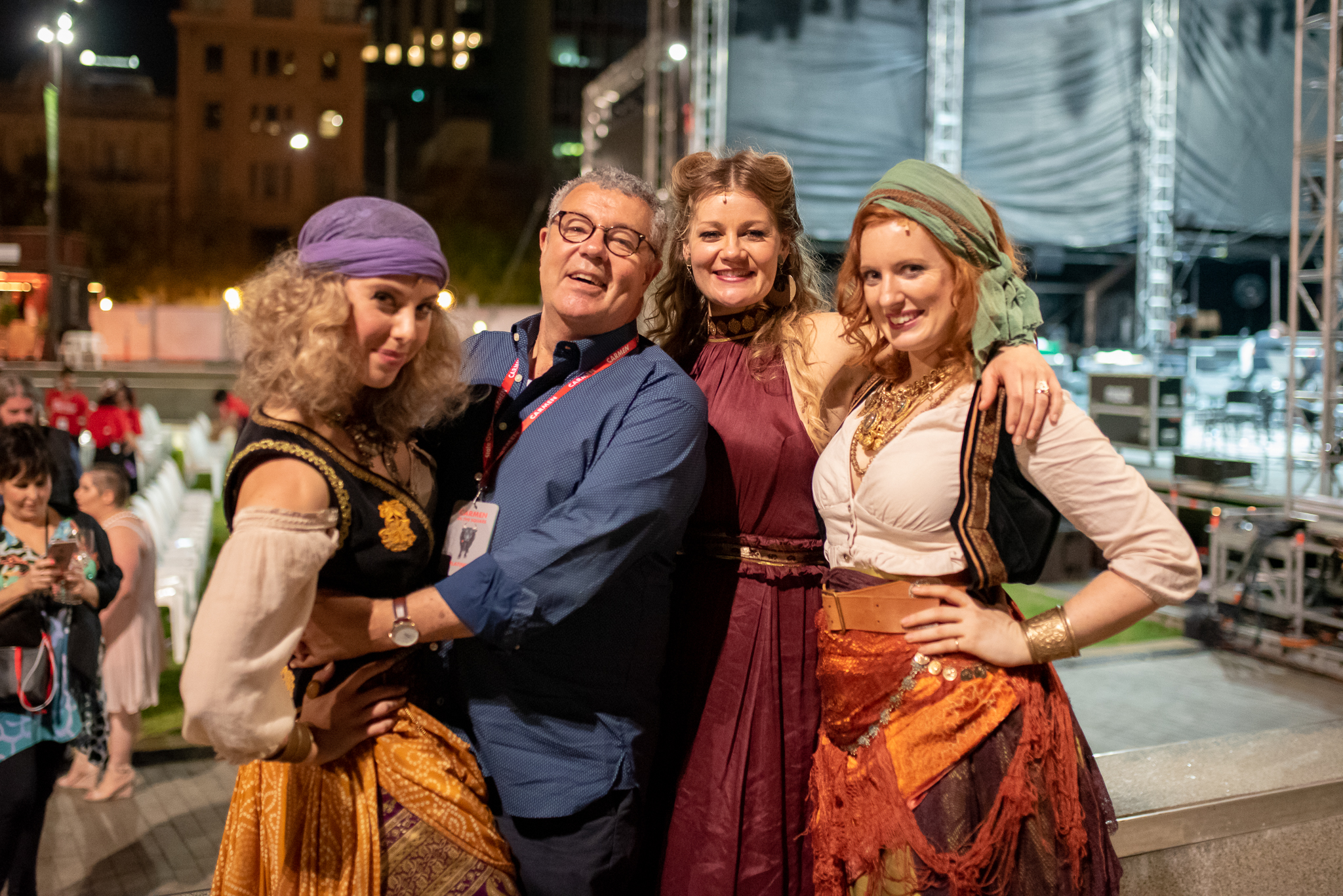 Artistic Director Stuart Maunder with three cast members from Carmen in costume